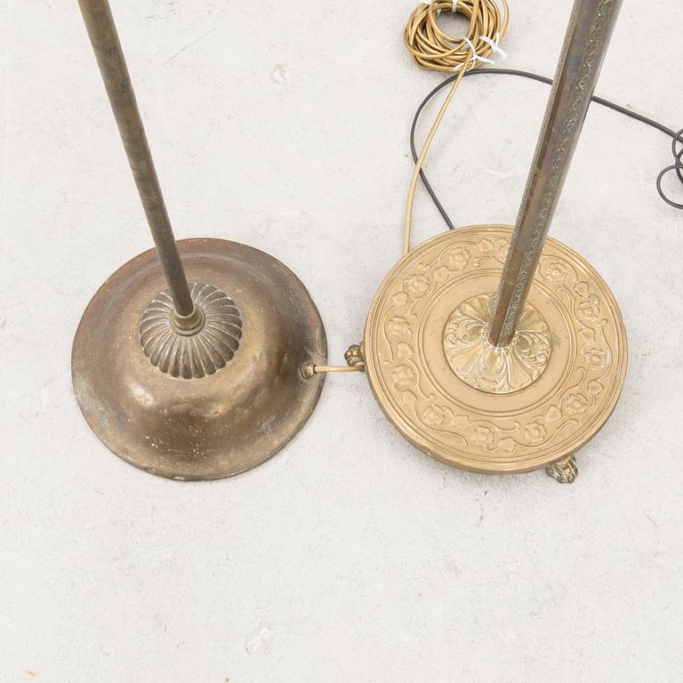 A set of two brass floor lamps later part of the 20th century.