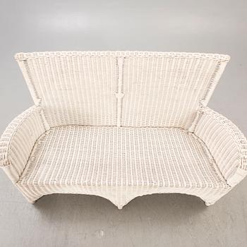 An Artwood rattan sofa.