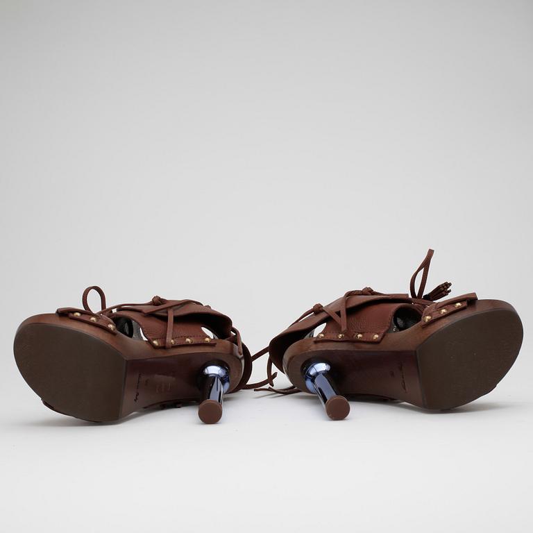 LOUIS VUITTON, a pair of brown leather platform sandalettes.