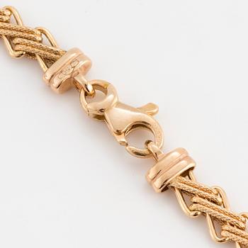 An 18K gold bracelet.