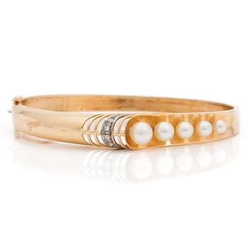 A bangle set with eight-cut diamonds and cultured pearls.