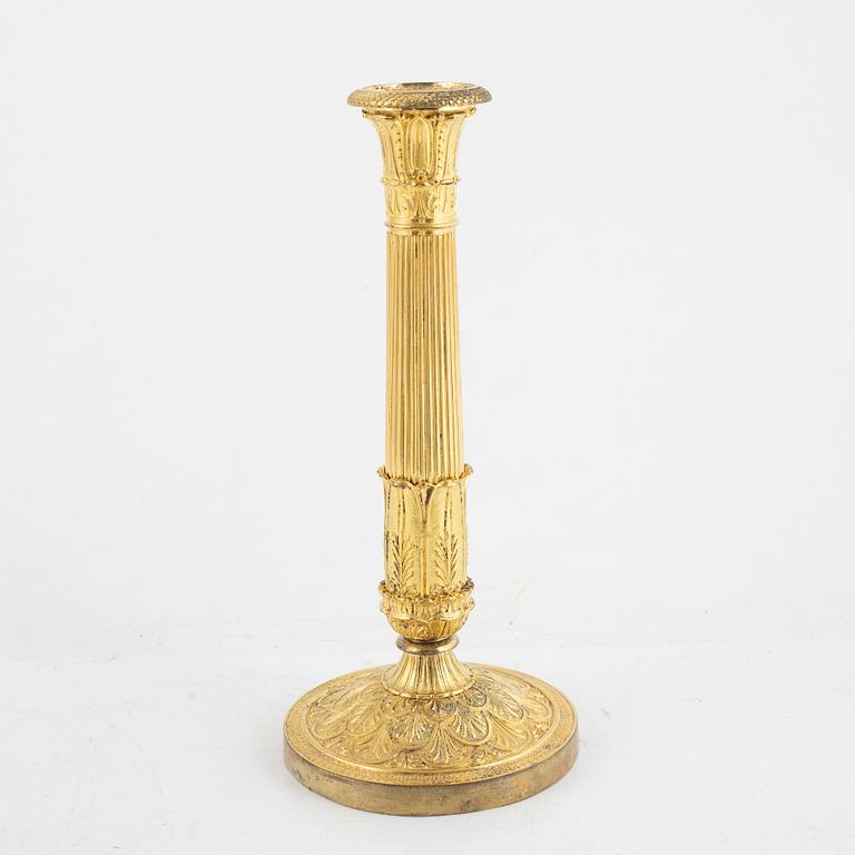 A French Empire gilt-bronze candlestick, early 19th century,