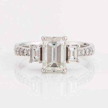 A RING set with an emerald-cut diamond.