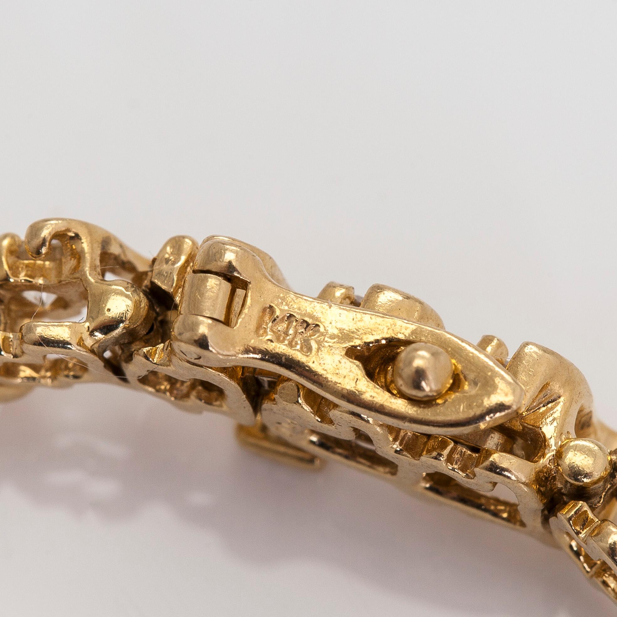 A 14K gold tennis bracelet, with brilliant-cut diamonds.