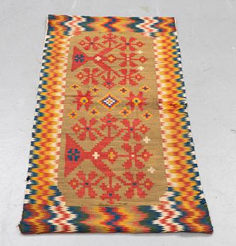 A carriage cushion, double-interlocked tapestry, ca 50 x 99,5 cm, Scania, (Sweden), first half of the 19th century.