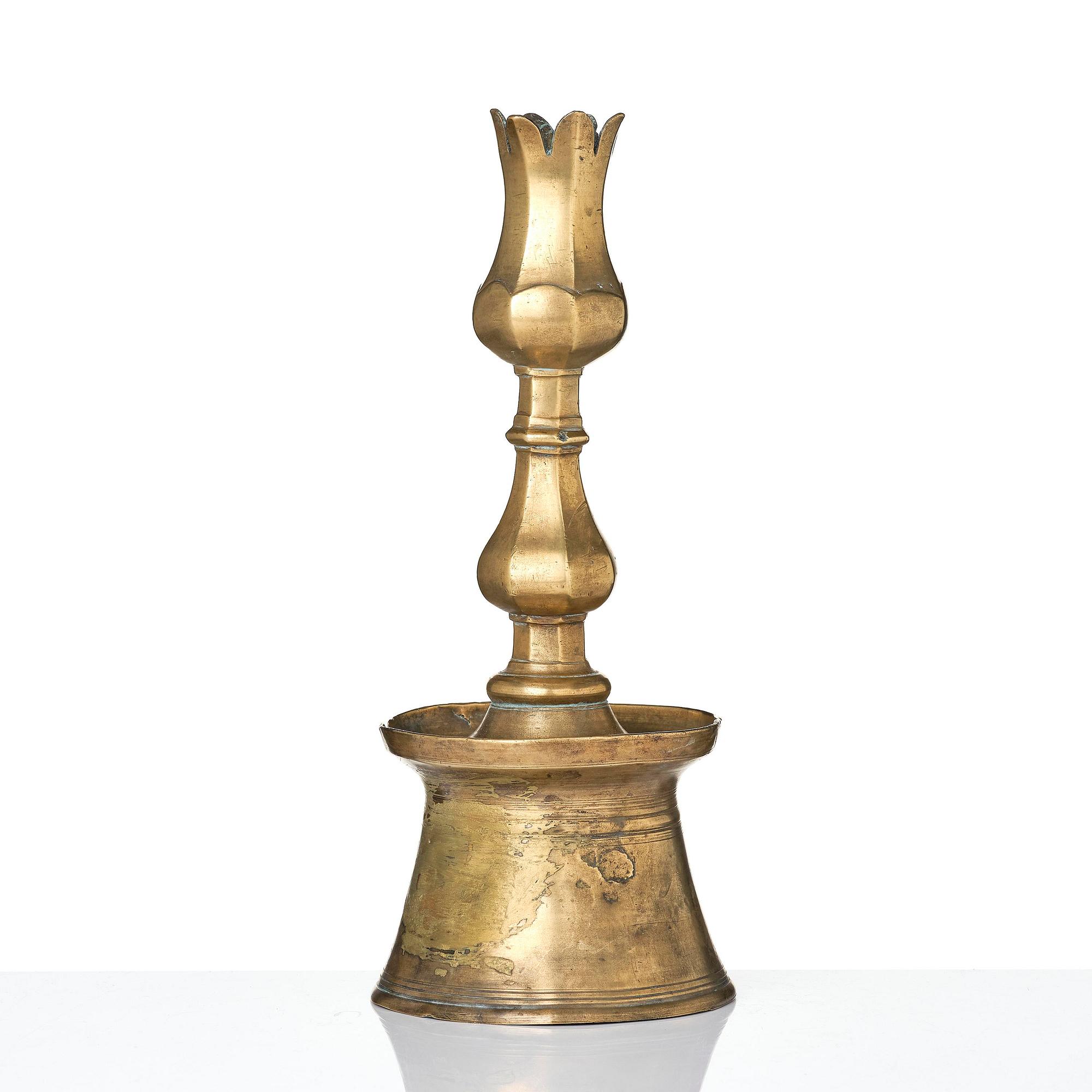 An Ottoman brass 'Tulip' Candelstick, Turkey, 17th/18th century.