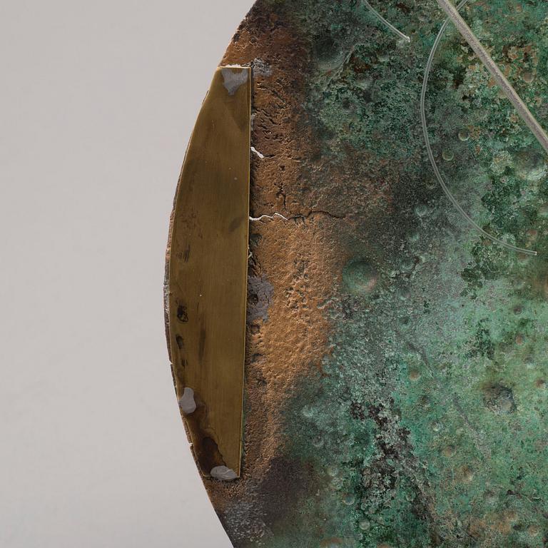 Three 20th century stone objects, with one bronze shield.