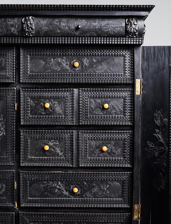 A Louis XIV and Louis XIV-style carved ebony, ivory and tortoiseshell-inlaid cabinet on stand, 17th and 19th century.