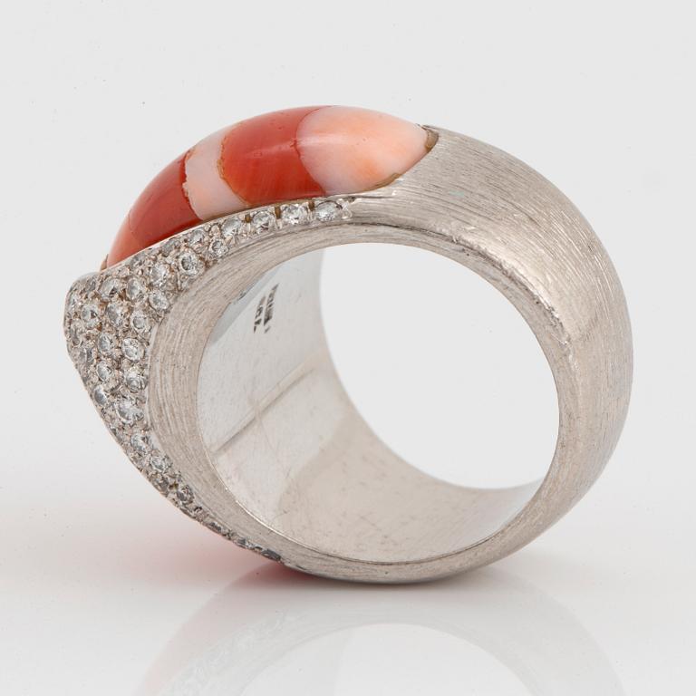 A Paul Binder ring in 18K white gold set with coral and round brillliant-cut diamonds.