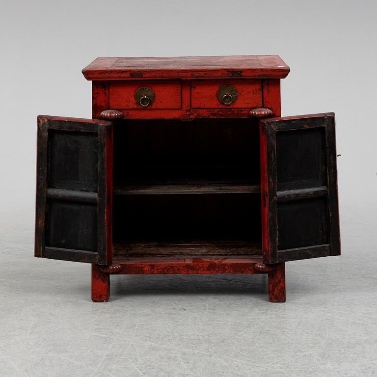 A red lacqured Chinese cabinet, 20th Century.