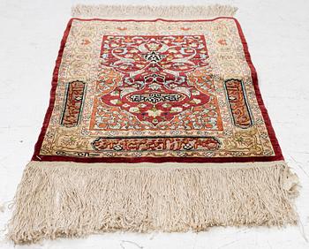 A silk and metal Hereke rug, West Anatolia, c. 58 x 39 cm.