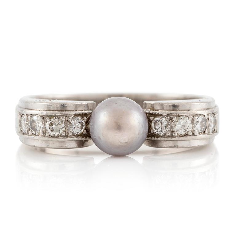 A W.A. Bolin ring in platinum with a pearl and round brilliant-cut diamonds.