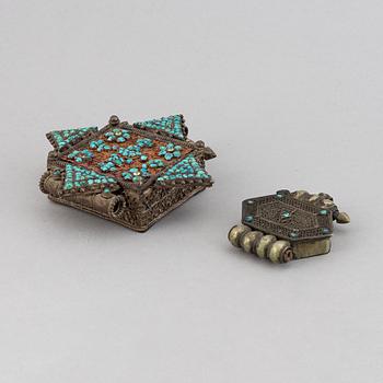 Two metal pendants with turkoise inlay, Tibet, circa 1900.