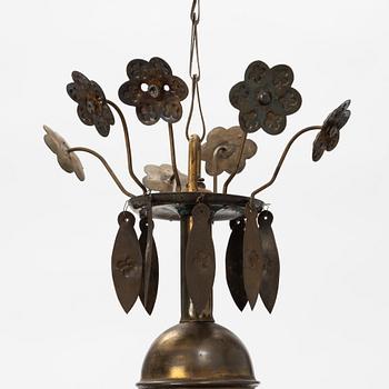 A Baroque style brass chandelier from around the year 1900.