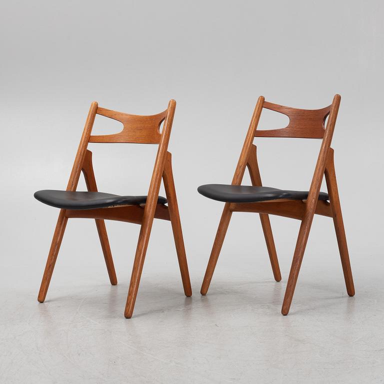 Hans J Wegner, a pair oak and teak CH29 'Savbukkestolen' chairs,Carl Hansen, mid 20th century.