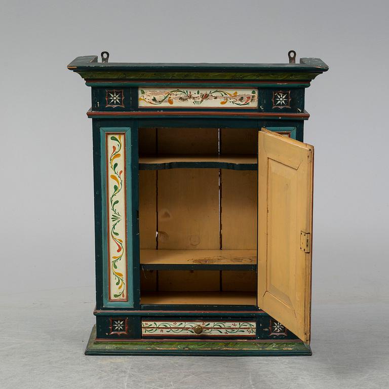 A painted wall cabinet, 19th century.