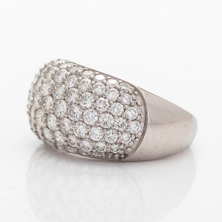 A platinum bombé ring with brilliant-cut diamonds.