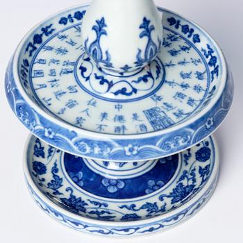 A pair of blue and white pricket candle sticks, with a poem, Qing dynasty with a Qianlong mark and of the period.