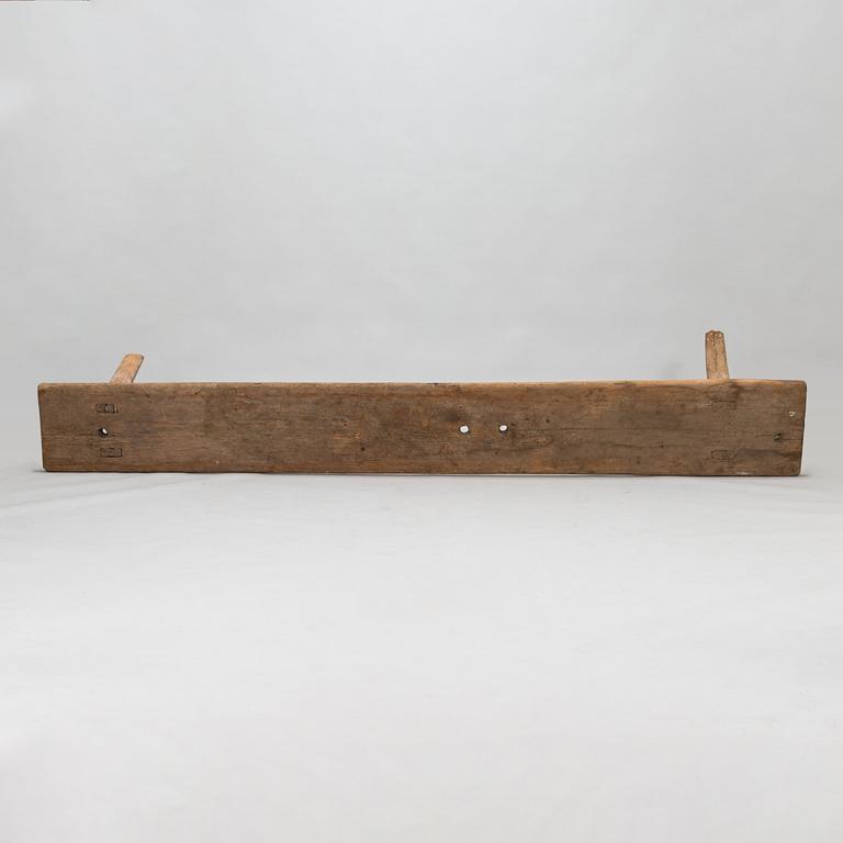 An 18th-century wooden bench dated 1782 with initials.