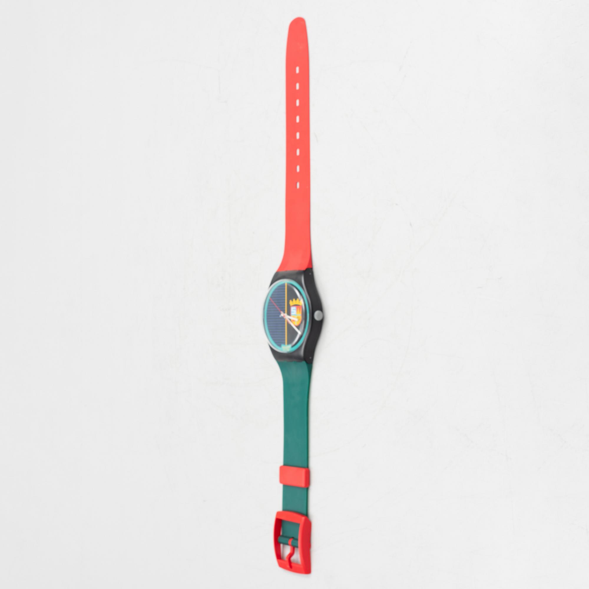 A wall clock, Swatch.