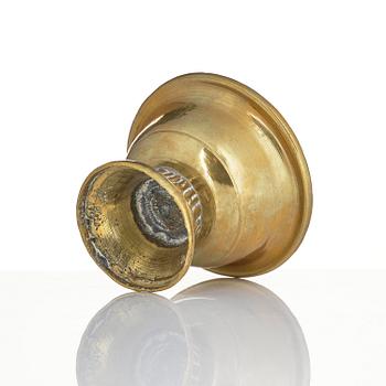 A bronze deity and a brass sacrificial bowl, Tibet, circa 1900.