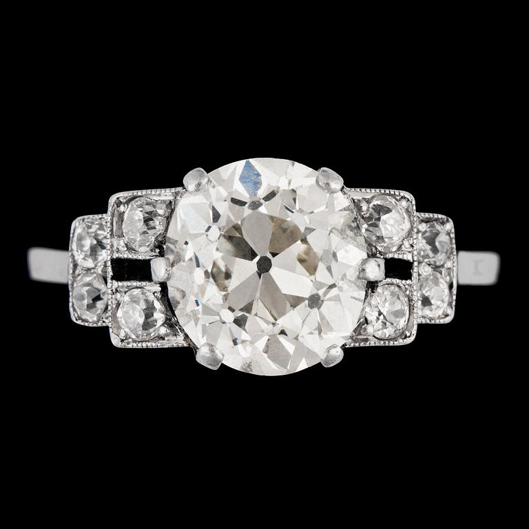 An antigue cut diamond ring, app. 3 cts, smaller diamonds set to the sides, tot. app. 0.30 cts. c. 1925.