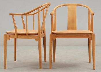 A pair of Hans J Wegner cherrywood and beige leather 'China chairs', Fritz Hansen, Denmark 1988.