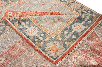 An oriental carpet with Mamluk design, c. 359 x 281 cm.