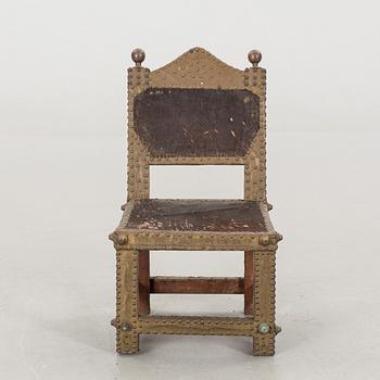 An Ashanti chair, Ghana, hardwood with brass studs, ca 1900.
