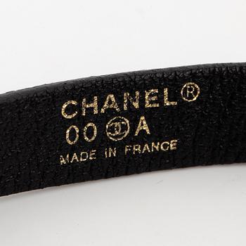 CHANEL, a leather bracelet.