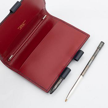 Hermès, a black leather notebook case & sterling silver pen.