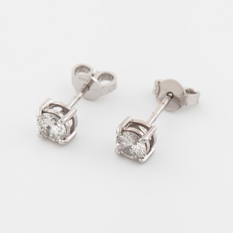 A pair of brilliant cut diamond earrings.