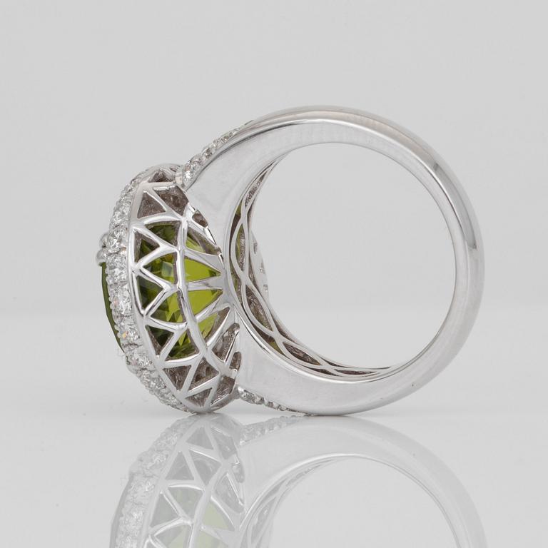 A Burmese 8.50 ct peridot and pavé-set diamond ring. Total carat weight of diamonds circa 2.00 cts.