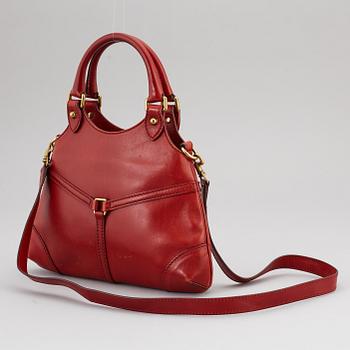 GUCCI, a red leather crossbody bag.