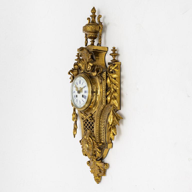 A bronze wall clock, Louis XVI style, France, circa 1900.