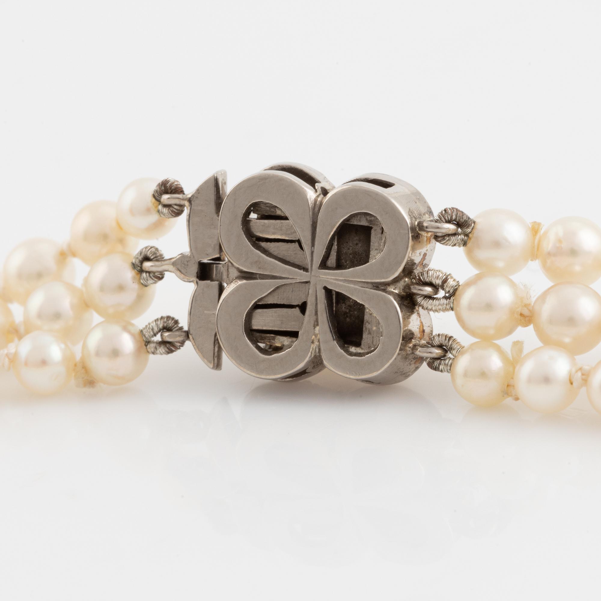 Three strand calibrated cultured pearl necklace, clasp with pearl and rose cut diamonds.
