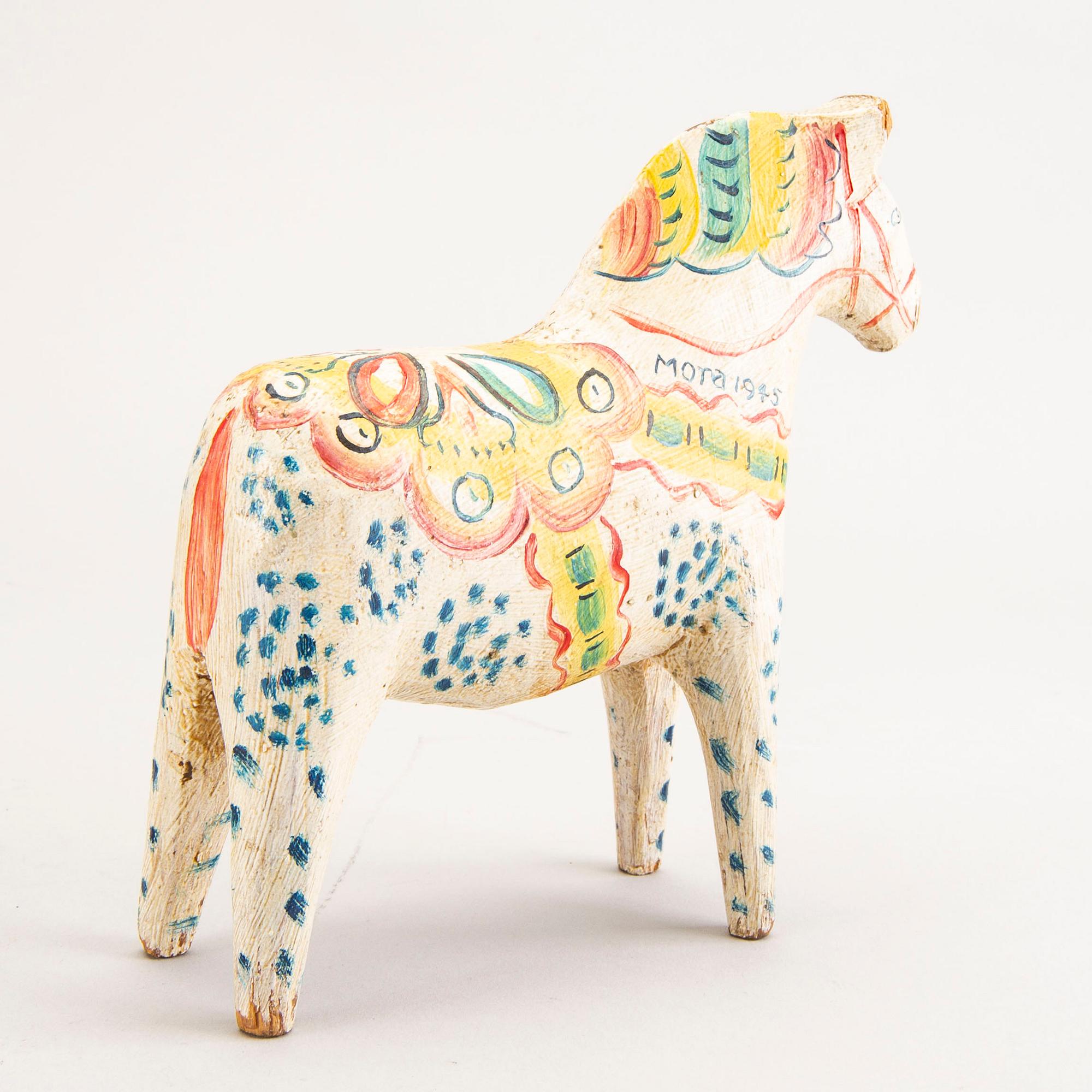 A Swedish painted and dated 1945 wooden horse.