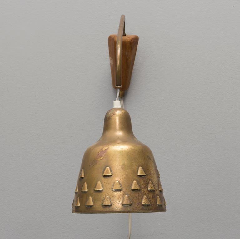 a 1950's brass and teak wall light.