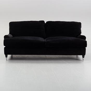 A contemporary velvet Howard sofa.
