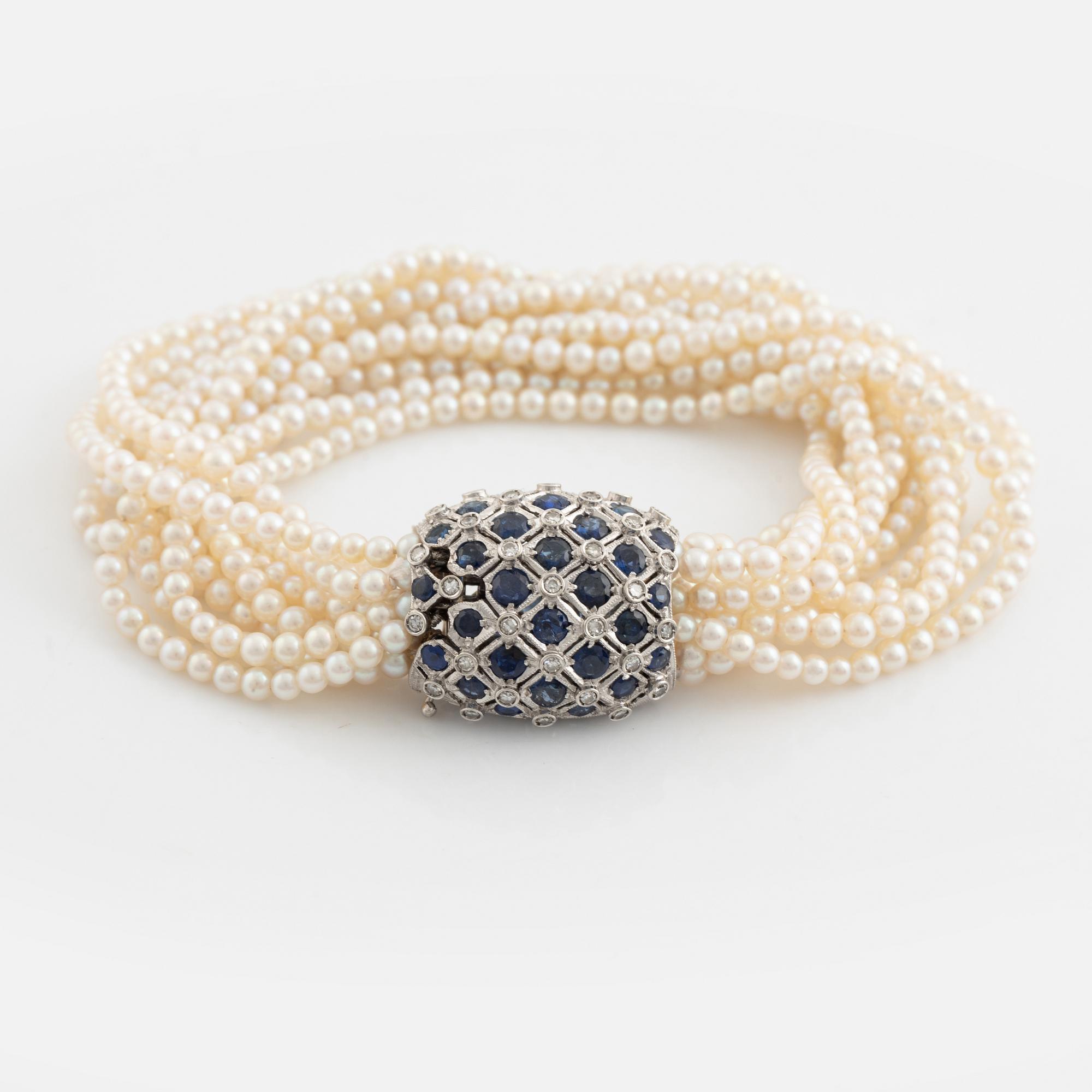 Cultured pearl bracelet, eleven strand, clasp white gold with sapphire and diamonds.