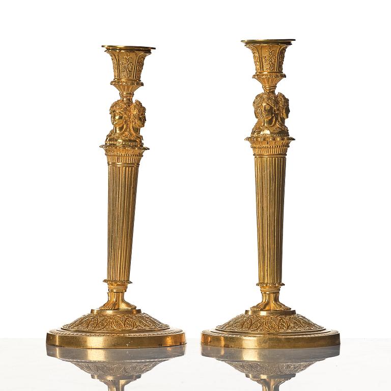 A pair of French Empire early 19th century gilt bronze candlesticks.