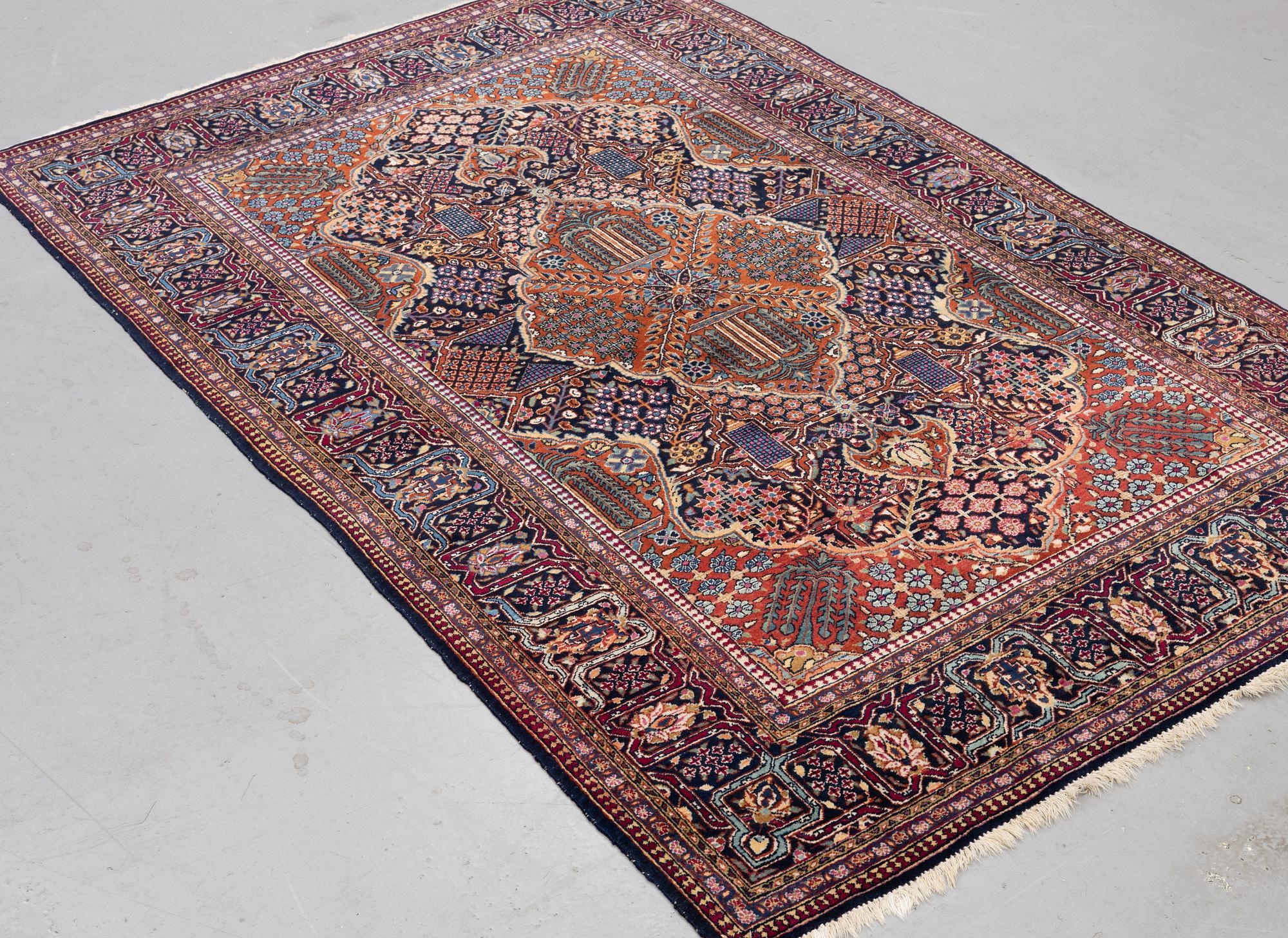 A rug, semi-antique Kashan, ca 216,5 x 140 cm.