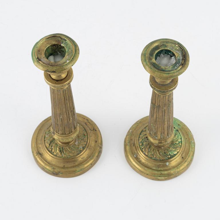 A pair of Empire bronze candlesticks, first half of the 19th Century.