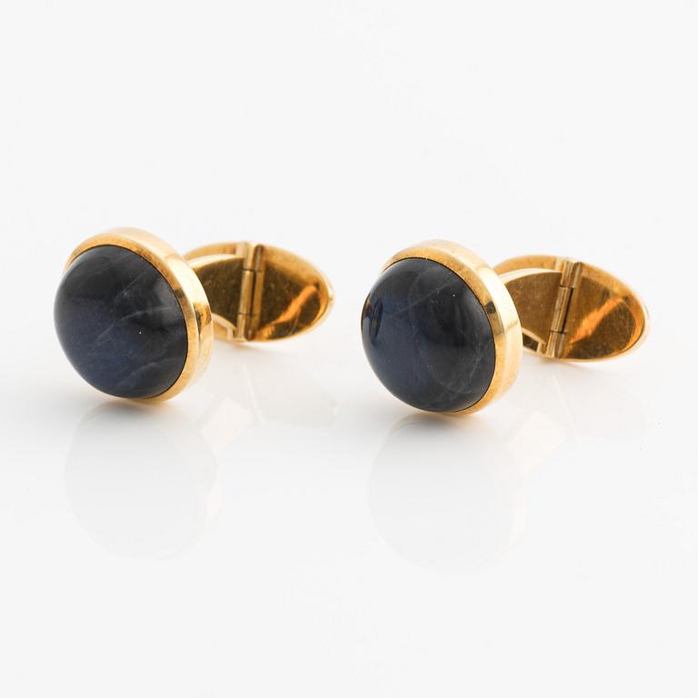 CF Carlman a pair of 18K gold cufflinks with a blue stone, likely spectrolite.