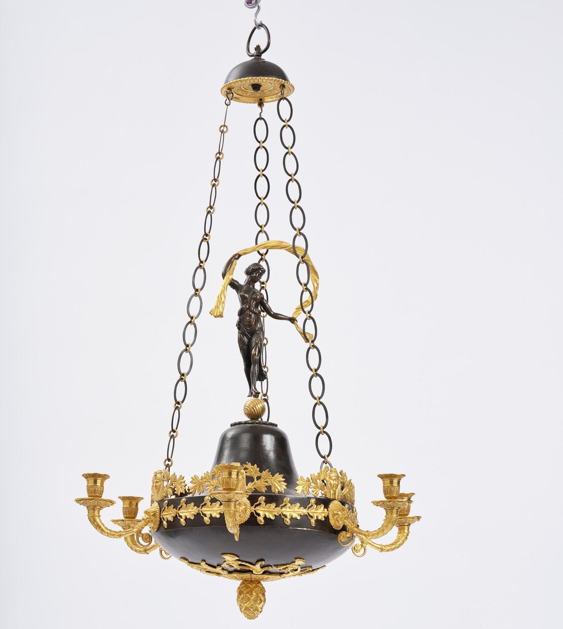 A patinated and ormolu six-light Empire chandelier, Stockholm, first part 19th century.