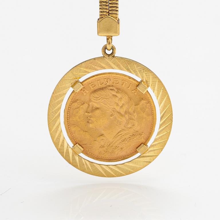 A keychain made of 18K gold with a 900 gold Helvetia 20 franc coin.