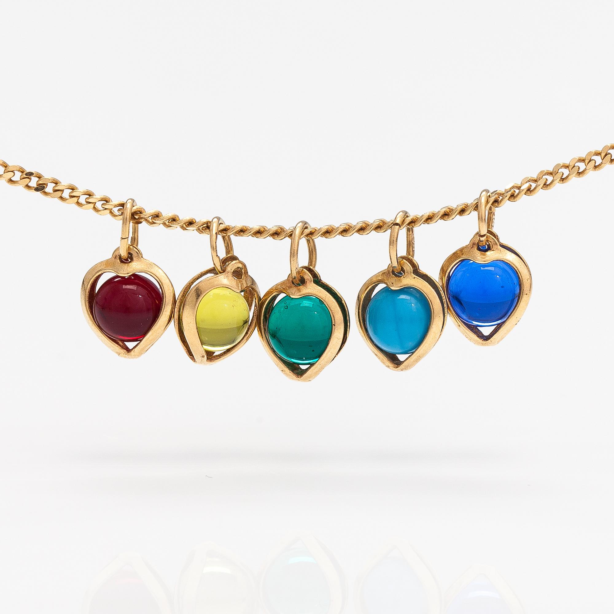 A 14K gold neckalce with glass pearls.