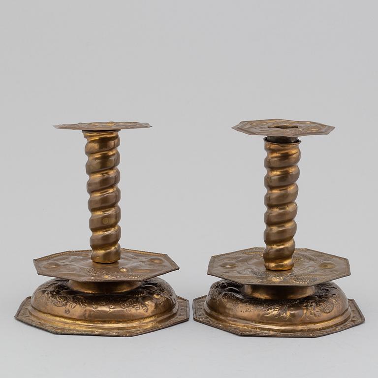 A pair of possibly 17th century brass candlesticks.