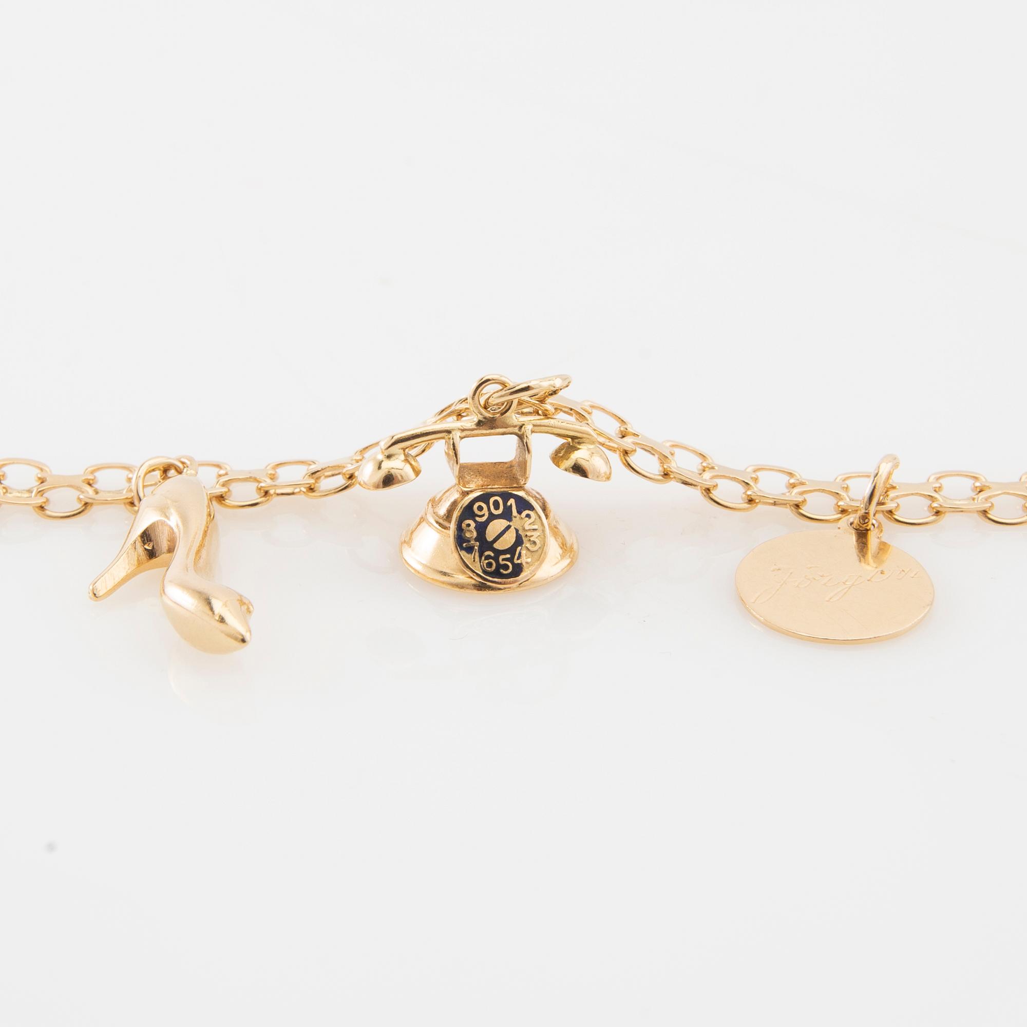 Bracelet 18K gold Bismarck link with charms.