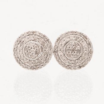A pair of 14K white gold earrings set with round single-cut diamonds.
